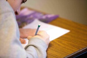 Student taking an AP exam and writing free-response answers